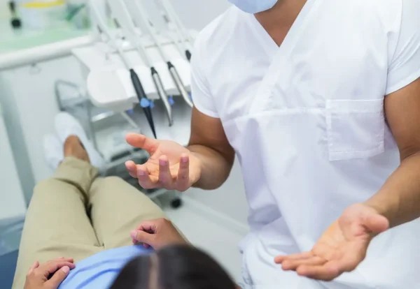 dentist-having-conversation-with-female-patient