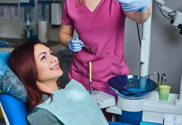 young-redhead-woman-having-examination-while-sitting-dental-chair-clinic